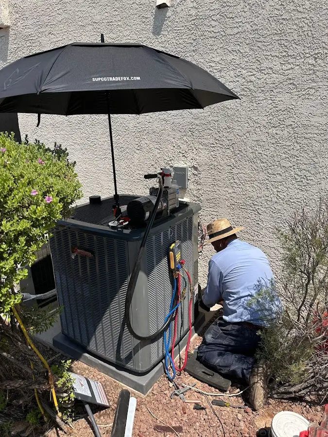HVAC technician performing outdoor AC maintenance in Delhi